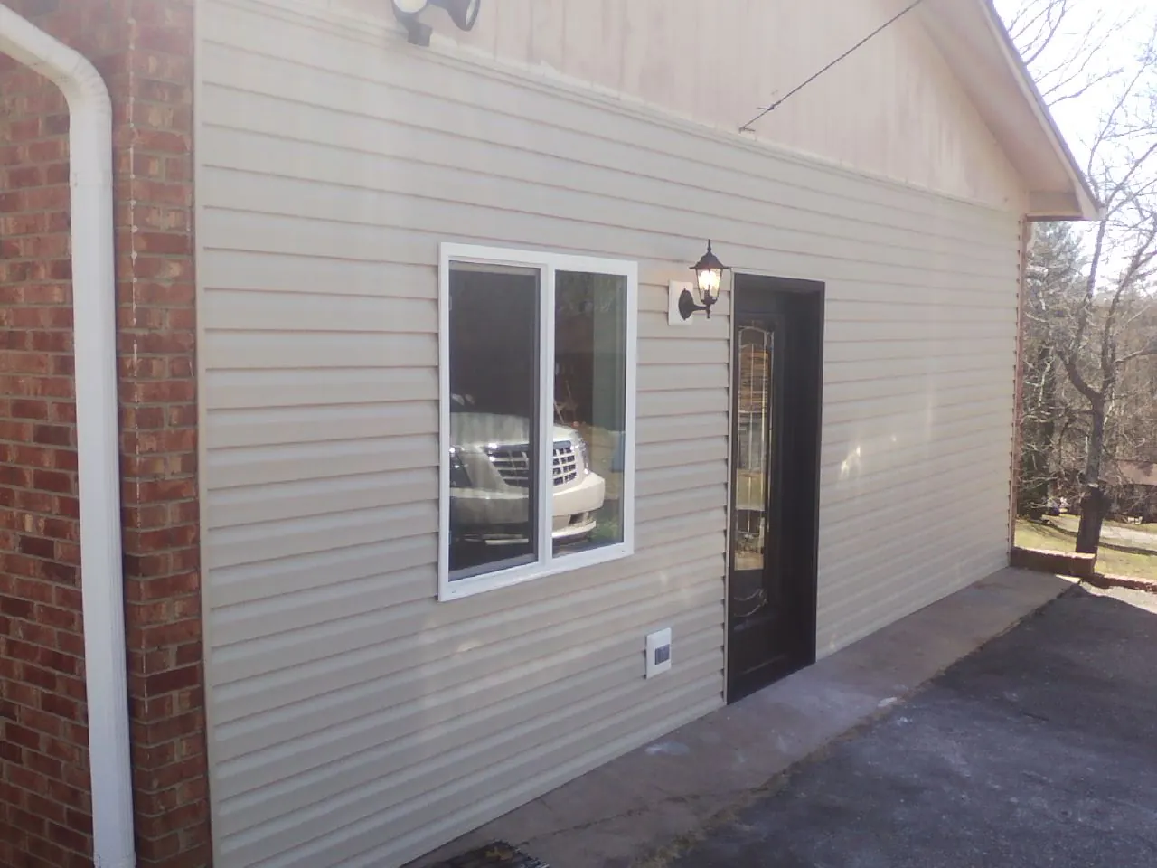 New vinyl siding and entry door on a room addition in Danville